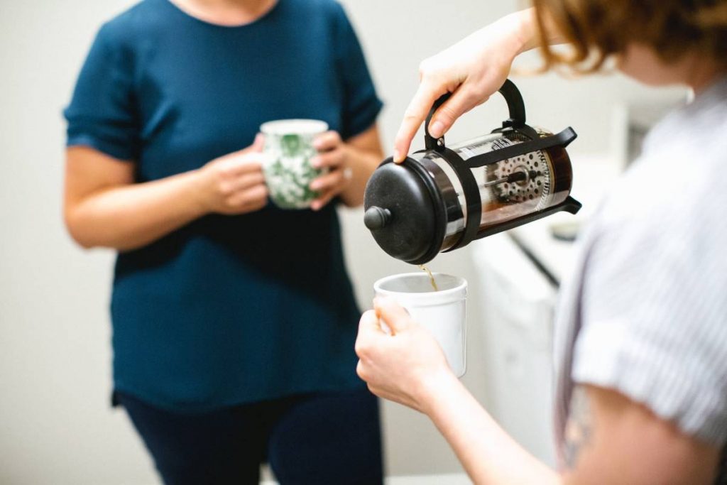 Women drinking coffee from a French press